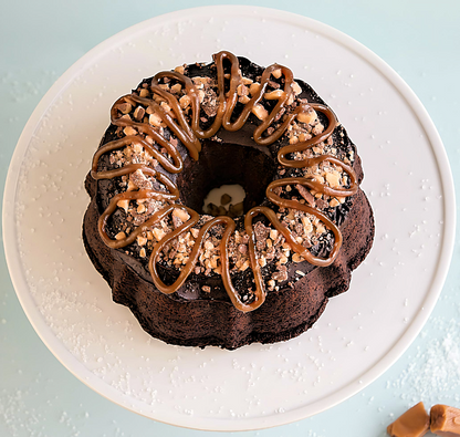 Get ready to indulge in a heavenly delight with our Brunette Salted Caramel Bundt Cake. This delectable treat boasts a luscious Double Chocolate cake, topped with a mouthwatering combination of toffee, sea salt, smooth chocolate ganache, and creamy caramel. Treat yourself to a moment of pure bliss!